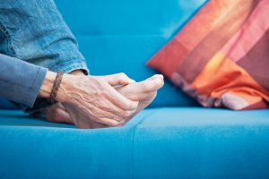 Typical gout-related pain in the metatarsophalangeal joint. XXL size image.