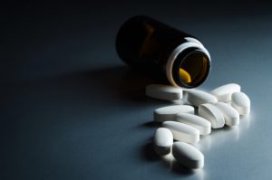 medical bottle and pills on background