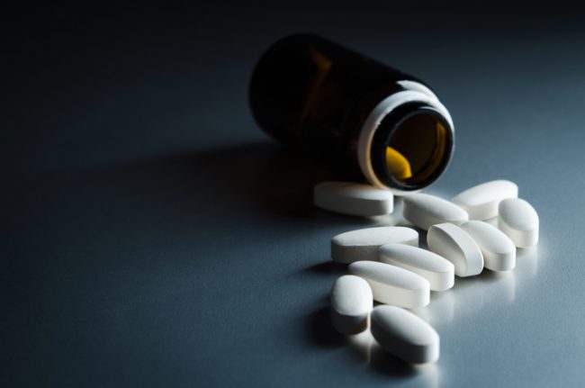 medical bottle and pills on background
